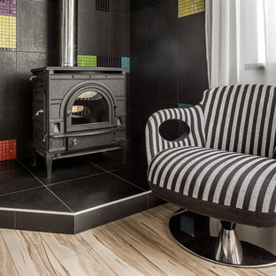 Inspiration for a contemporary home office in Other with white walls, light hardwood floors and a wood stove.