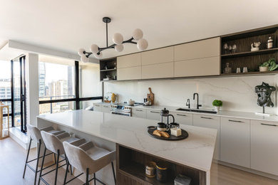 Example of a trendy l-shaped laminate floor and beige floor eat-in kitchen design in Vancouver with a double-bowl sink, flat-panel cabinets, dark wood cabinets, quartz countertops, white backsplash, quartz backsplash, stainless steel appliances, an island and white countertops