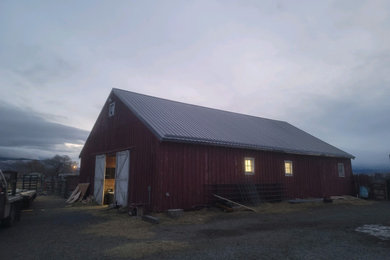 Example of a large cottage detached barn design in Other