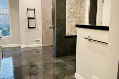 Example of a minimalist master gray tile and porcelain tile porcelain tile, black floor and double-sink bathroom design in Other with flat-panel cabinets, gray cabinets, a bidet, gray walls, granite countertops, white countertops, a niche and a floating vanity