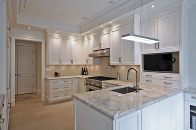 Photo of a mid-sized transitional u-shaped eat-in kitchen in Toronto with an undermount sink, white cabinets, beige splashback, stainless steel appliances, dark hardwood floors, recessed-panel cabinets, granite benchtops, ceramic splashback, a peninsula, brown floor and brown benchtop.