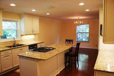 Eat-in kitchen - mid-sized traditional galley medium tone wood floor eat-in kitchen idea in Other with a double-bowl sink, recessed-panel cabinets, white cabinets, granite countertops, white backsplash, ceramic backsplash, stainless steel appliances and an island