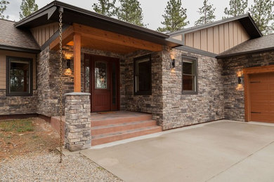 Entryway - mid-sized rustic concrete floor entryway idea in Other with beige walls and a dark wood front door