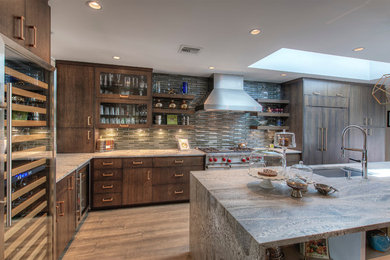 Mid-sized trendy l-shaped medium tone wood floor and brown floor kitchen photo in Phoenix with an undermount sink, flat-panel cabinets, medium tone wood cabinets, gray backsplash, matchstick tile backsplash, paneled appliances and an island