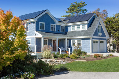 This is an example of a mid-sized traditional two-storey blue exterior in Providence with mixed siding and a gable roof.
