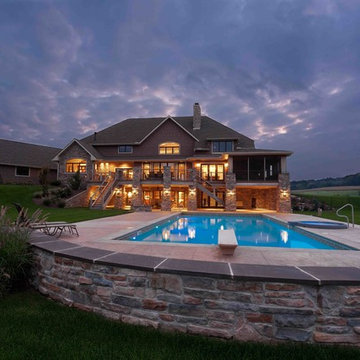 Exterior featuring pool and two-story outdoor living space