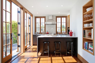 Inspiration for a mid-sized contemporary galley medium tone wood floor eat-in kitchen remodel in San Francisco with open cabinets, medium tone wood cabinets, white backsplash, a drop-in sink, quartzite countertops, ceramic backsplash, stainless steel appliances and an island