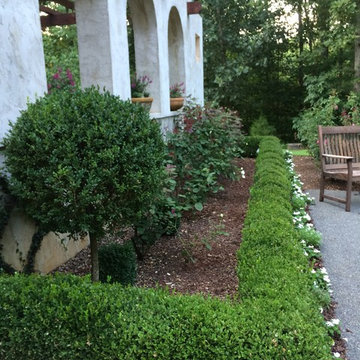 Formal garden rooms around this Mission-style home give it roots in the Carolina