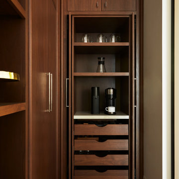Walnut Pocket Doors Unveil a Stylish Kitchen Pantry Coffee Station