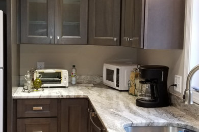 Eat-in kitchen - mid-sized contemporary l-shaped light wood floor and beige floor eat-in kitchen idea in Other with an undermount sink, shaker cabinets, gray cabinets, granite countertops, stainless steel appliances, no island and multicolored countertops