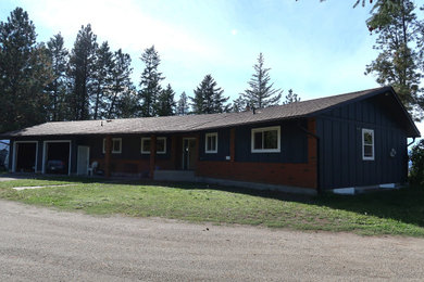 Example of a trendy blue concrete fiberboard and board and batten house exterior design in Other