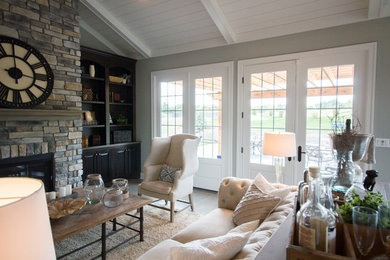 Inspiration for a mid-sized transitional formal and open concept medium tone wood floor and brown floor living room remodel in Cincinnati with gray walls, a standard fireplace and a stone fireplace