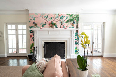 Large beach style open concept dark wood floor living room photo in Philadelphia with white walls, a standard fireplace, a plaster fireplace and a wall-mounted tv