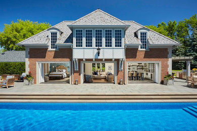 Inspiration for a timeless two-story brick house exterior remodel in Minneapolis with a hip roof and a shingle roof