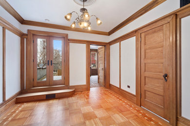 Inspiration for a mid-sized timeless medium tone wood floor and brown floor dining room remodel in Salt Lake City with white walls