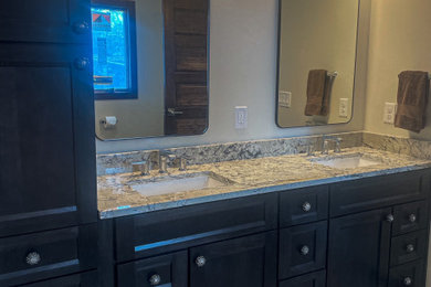 Walk-in shower - large master wood-look tile floor and double-sink walk-in shower idea in Other with dark wood cabinets, an undermount sink, quartzite countertops and multicolored countertops