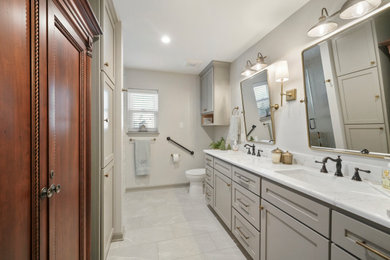 Mid-sized trendy master white tile and ceramic tile ceramic tile, white floor and double-sink walk-in shower photo in Houston with shaker cabinets, gray cabinets, a two-piece toilet, gray walls, an undermount sink, quartz countertops, a hinged shower door, white countertops, a niche and a built-in vanity