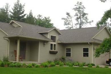 Mid-sized elegant green one-story exterior home photo in Other