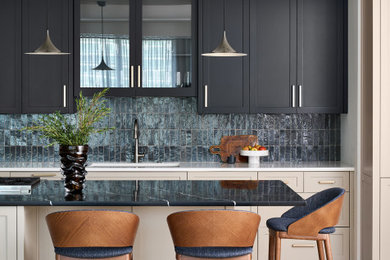 Mid-sized transitional galley light wood floor and brown floor open concept kitchen photo in Chicago with an undermount sink, recessed-panel cabinets, beige cabinets, quartz countertops, gray backsplash, ceramic backsplash, paneled appliances, an island and black countertops