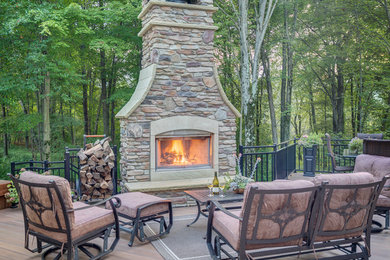 Large elegant backyard patio photo in Cleveland with no cover, a fire pit and decking