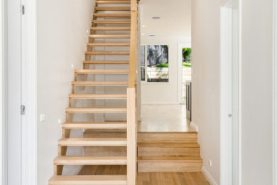 Design ideas for a small transitional wood straight staircase in Melbourne with open risers and cable railing.
