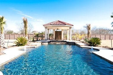 Hot tub - mid-sized mediterranean backyard concrete paver and rectangular hot tub idea in Houston