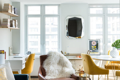 Example of a small open concept medium tone wood floor living room design in New York with white walls and a wall-mounted tv