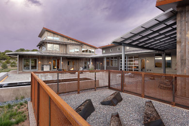 Mid-sized minimalist brown two-story mixed siding house exterior photo in Denver with a shed roof and a metal roof