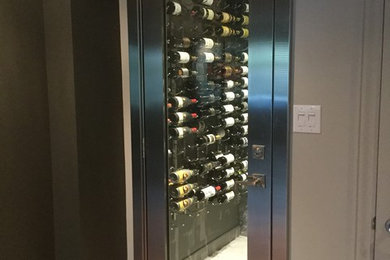 Inspiration for a mid-sized porcelain tile wine cellar remodel in Ottawa