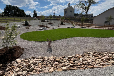 This is an example of a large farmhouse drought-tolerant and full sun backyard brick landscaping in Denver with a fire pit for fall.