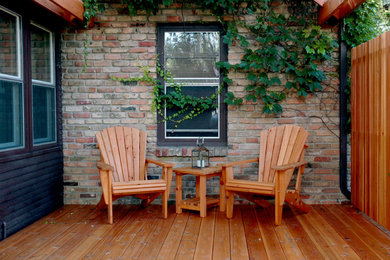 Elegant back porch photo in Minneapolis with decking