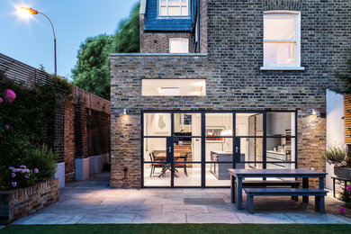 This is an example of a contemporary backyard deck in London.