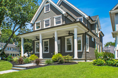 Inspiration for a mid-sized timeless gray three-story vinyl exterior home remodel in New York with a shingle roof