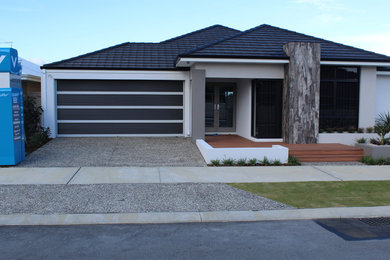Photo of a mid-sized contemporary front yard full sun driveway in Perth.