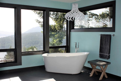 Inspiration for a large modern master bathroom in Vancouver with shaker cabinets, white cabinets, a freestanding tub, a corner shower, a two-piece toilet, gray tile, mosaic tile, green walls, porcelain floors, an undermount sink, marble benchtops and black floor.