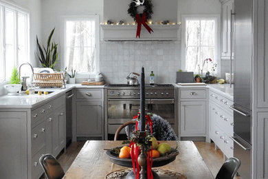 Inspiration for a small farmhouse u-shaped light wood floor and beige floor eat-in kitchen remodel in New York with shaker cabinets, white cabinets, no island, an undermount sink, marble countertops, white backsplash, stainless steel appliances and white countertops
