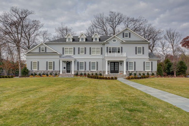 Inspiration for a timeless gray two-story wood gable roof remodel in New York