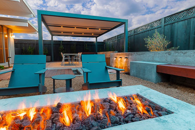 Inspiration for a mid-sized modern backyard patio remodel in San Francisco with a fire pit and a pergola