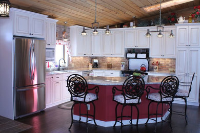 Eat-in kitchen - large country l-shaped dark wood floor eat-in kitchen idea in Denver with an undermount sink, raised-panel cabinets, white cabinets, granite countertops, multicolored backsplash, stainless steel appliances and an island