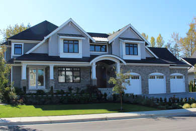 Arts and crafts two-story mixed siding exterior home photo in Vancouver with a shingle roof