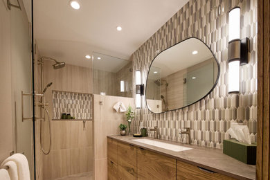 Inspiration for a mid-sized 1950s master brown tile and ceramic tile ceramic tile, multicolored floor and single-sink alcove shower remodel in Portland with flat-panel cabinets, medium tone wood cabinets, multicolored walls, an undermount sink, quartz countertops, a hinged shower door, brown countertops and a built-in vanity
