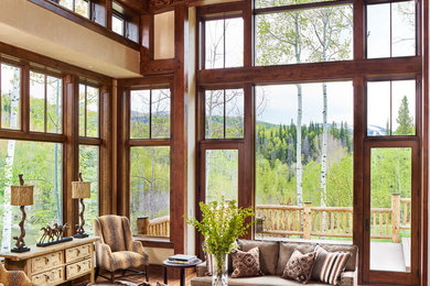 Example of a large transitional open concept medium tone wood floor living room design in Denver with beige walls
