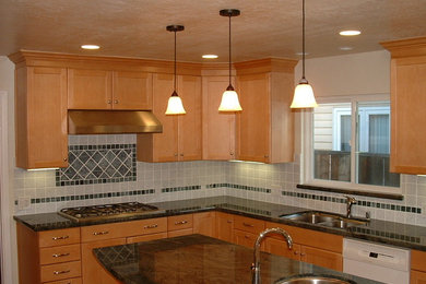 Kitchen - traditional l-shaped kitchen idea in Austin with a double-bowl sink, shaker cabinets, light wood cabinets, granite countertops, gray backsplash, ceramic backsplash, stainless steel appliances and an island