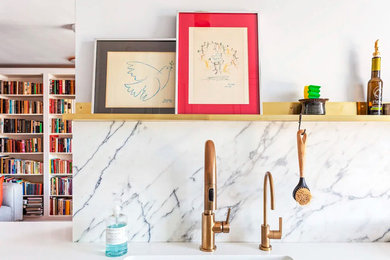 Kitchen - mid-sized contemporary galley medium tone wood floor and brown floor kitchen idea in New York with an undermount sink, shaker cabinets, white cabinets, quartz countertops, white backsplash, marble backsplash, paneled appliances, a peninsula and white countertops