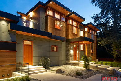 Large modern gray two-story mixed siding house exterior idea in Vancouver with a metal roof and a shed roof