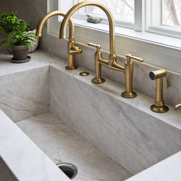 Custom Walnut and White Kitchen Remodel with Marble Slab Backsplash and Brass Ac