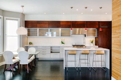 Eat-in kitchen - contemporary galley dark wood floor eat-in kitchen idea in San Francisco with an undermount sink, flat-panel cabinets, medium tone wood cabinets, quartz countertops, white backsplash, porcelain backsplash, paneled appliances and an island