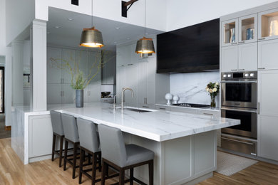Kitchen - large rustic l-shaped medium tone wood floor, brown floor and vaulted ceiling kitchen idea in Denver with an undermount sink, shaker cabinets, gray cabinets, marble countertops, marble backsplash, stainless steel appliances, an island, white backsplash and white countertops