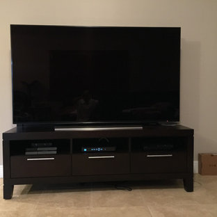 Design ideas for a medium sized contemporary open plan home cinema in Miami with beige walls and travertine flooring.