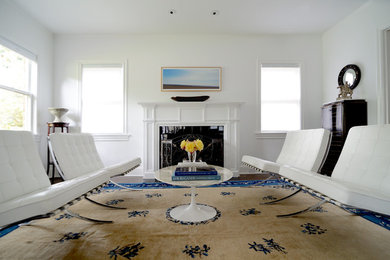 Mid-sized eclectic formal and enclosed medium tone wood floor and brown floor living room photo in Dallas with white walls, a standard fireplace, a wood fireplace surround and no tv
